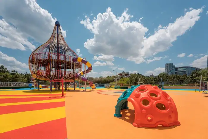 Multi-color EPDM playground surface with coordinated color zones and graphic patterns