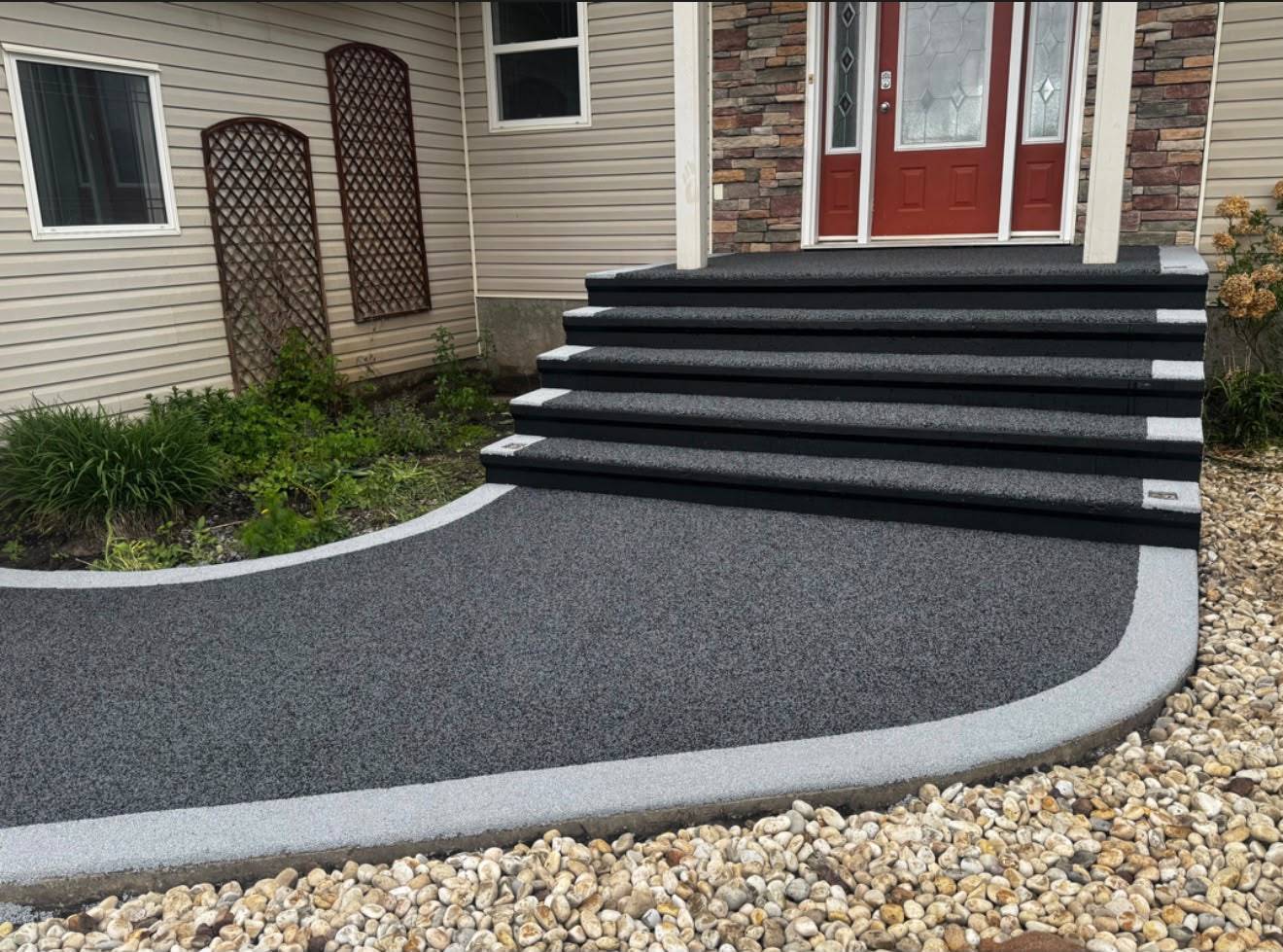 Rubber driveway and walkway integrated with a private home