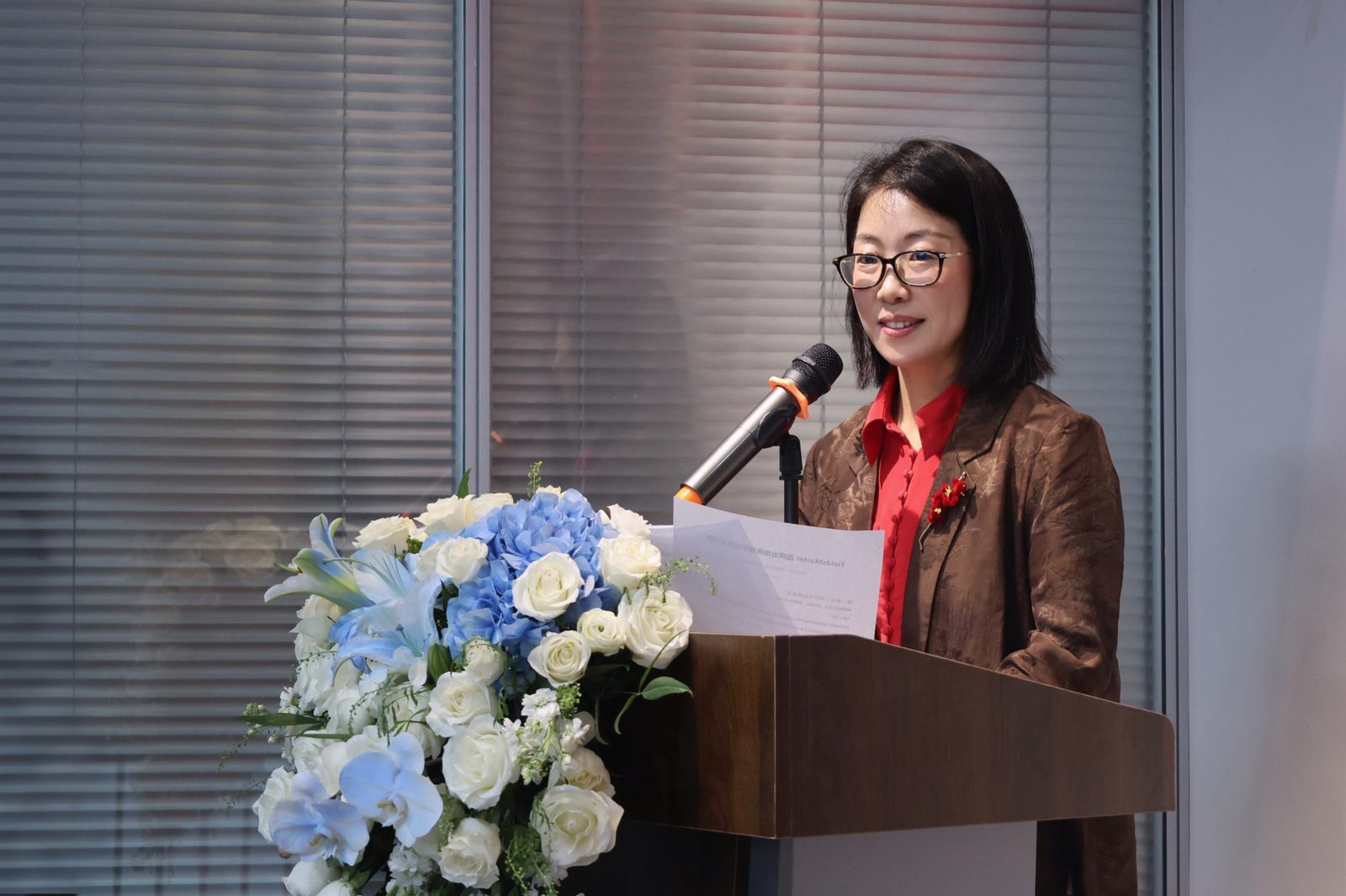Joyce, founder of FieldsMaster, speaking at the two-year anniversary celebration