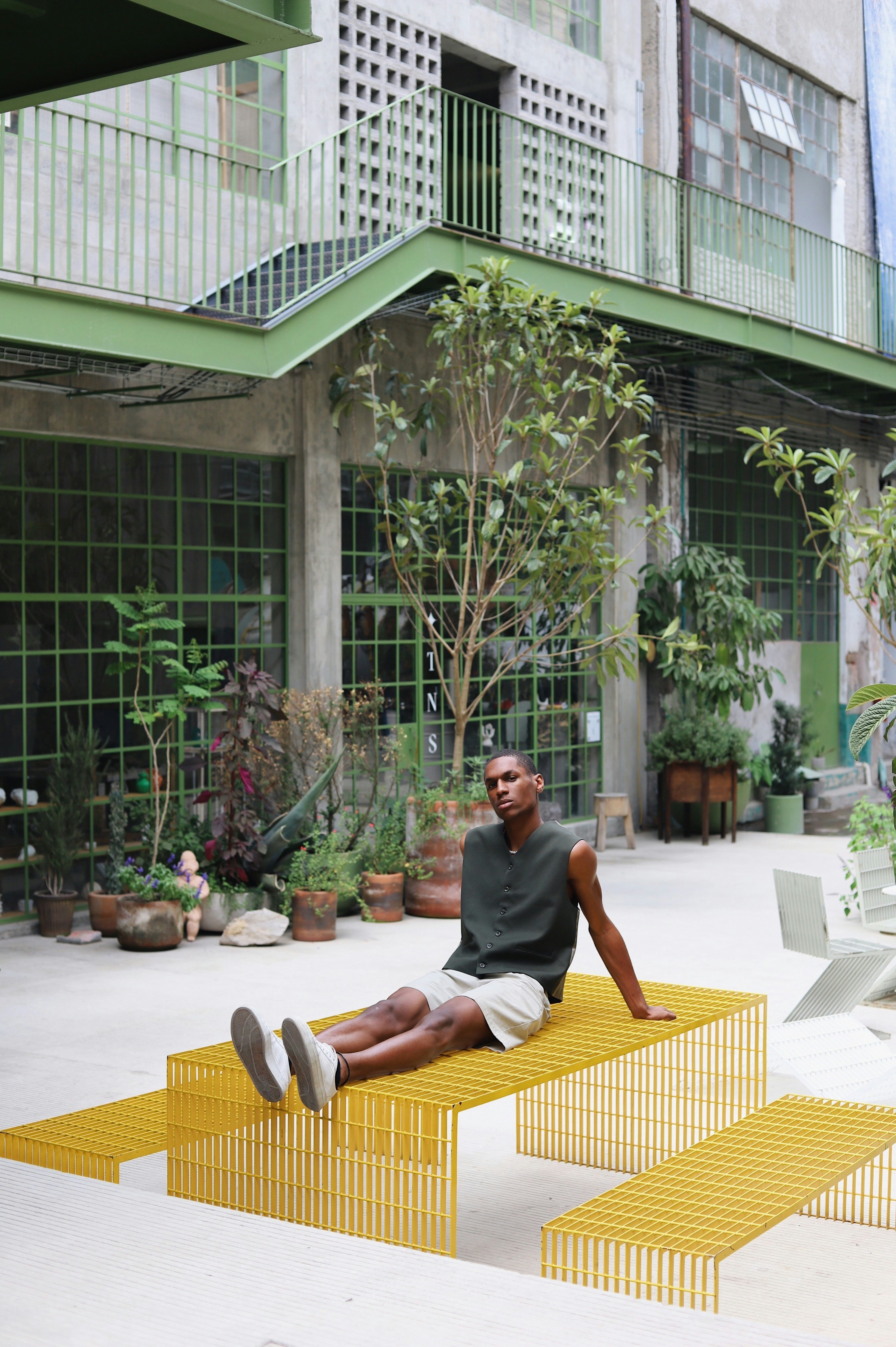 Person sitting on an outdoor chair in a relaxed setting