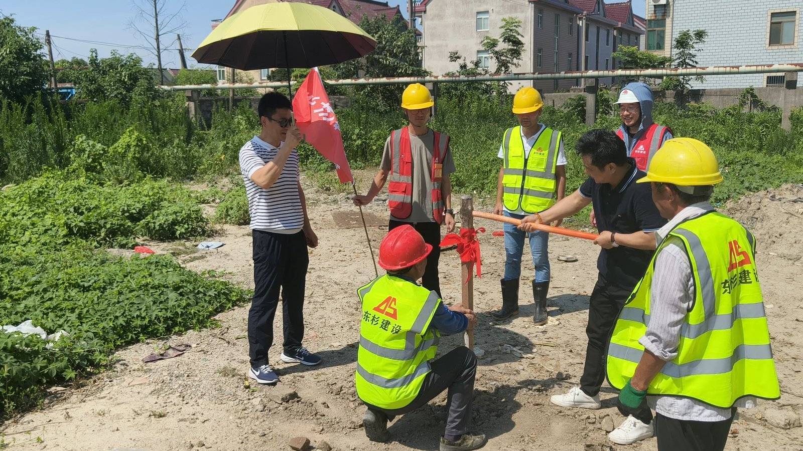 Quanshun Webbing leadership and construction team plant the ceremonial flag at the new factory site