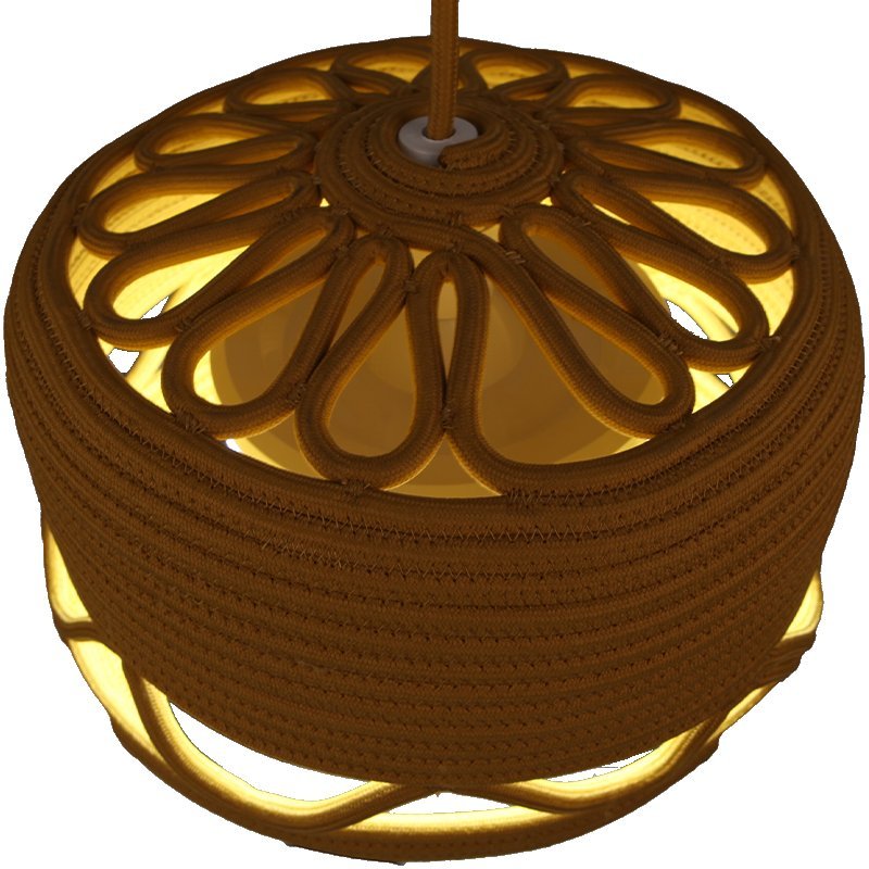 Wavy openwork band sends soft patterned light onto the room