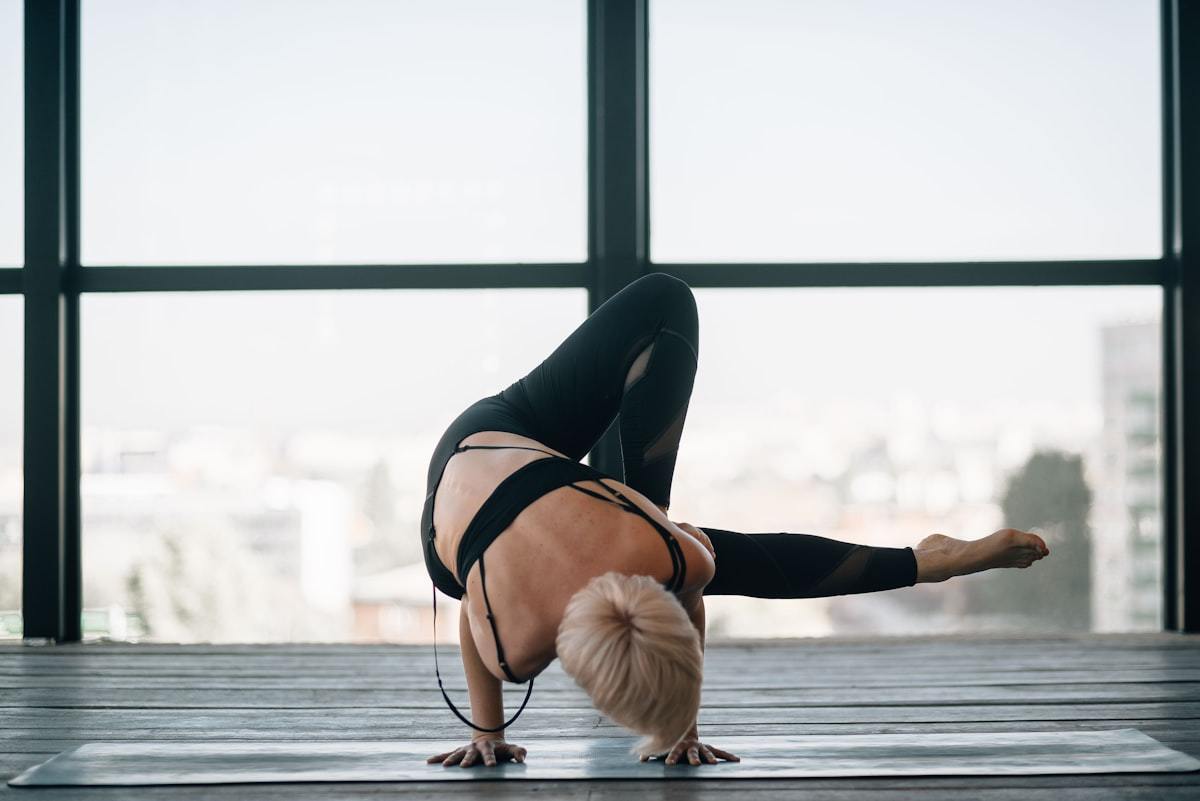 Athlete wearing logo-free black activewear during a yoga movement