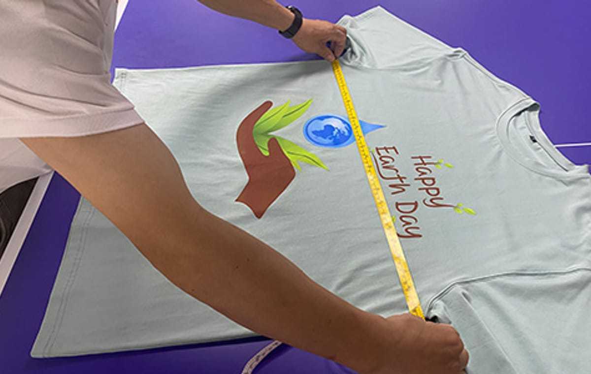 Ohsurewear team measuring a finished garment against the approved specification