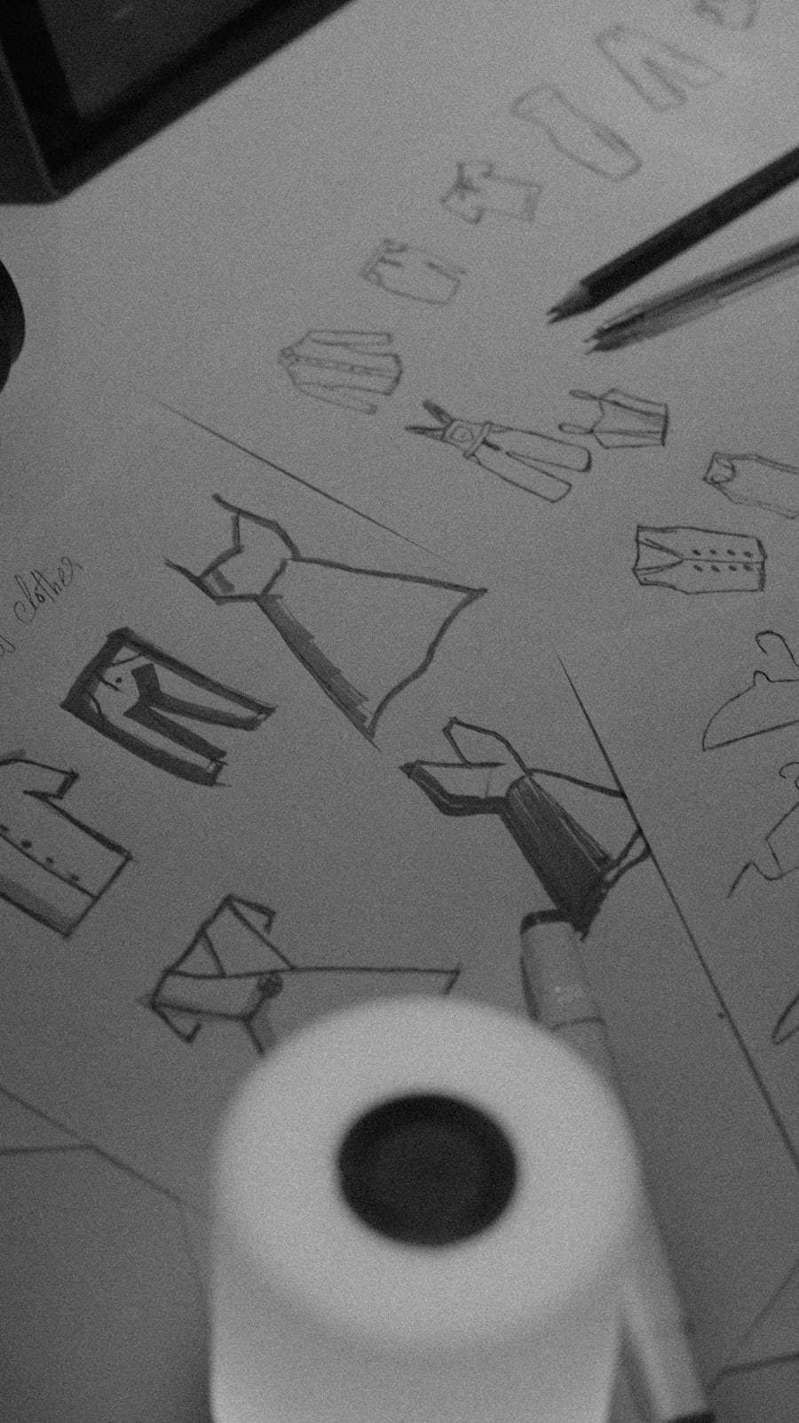 Apparel design sketches arranged with pencils and markers