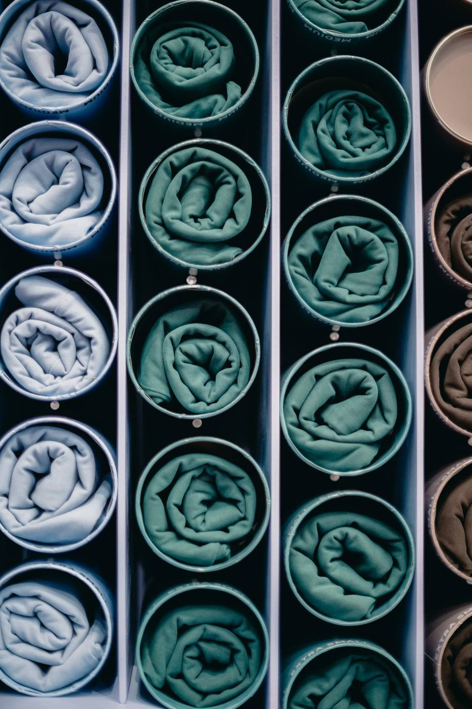Rolled fabric samples organized by available color in circular containers