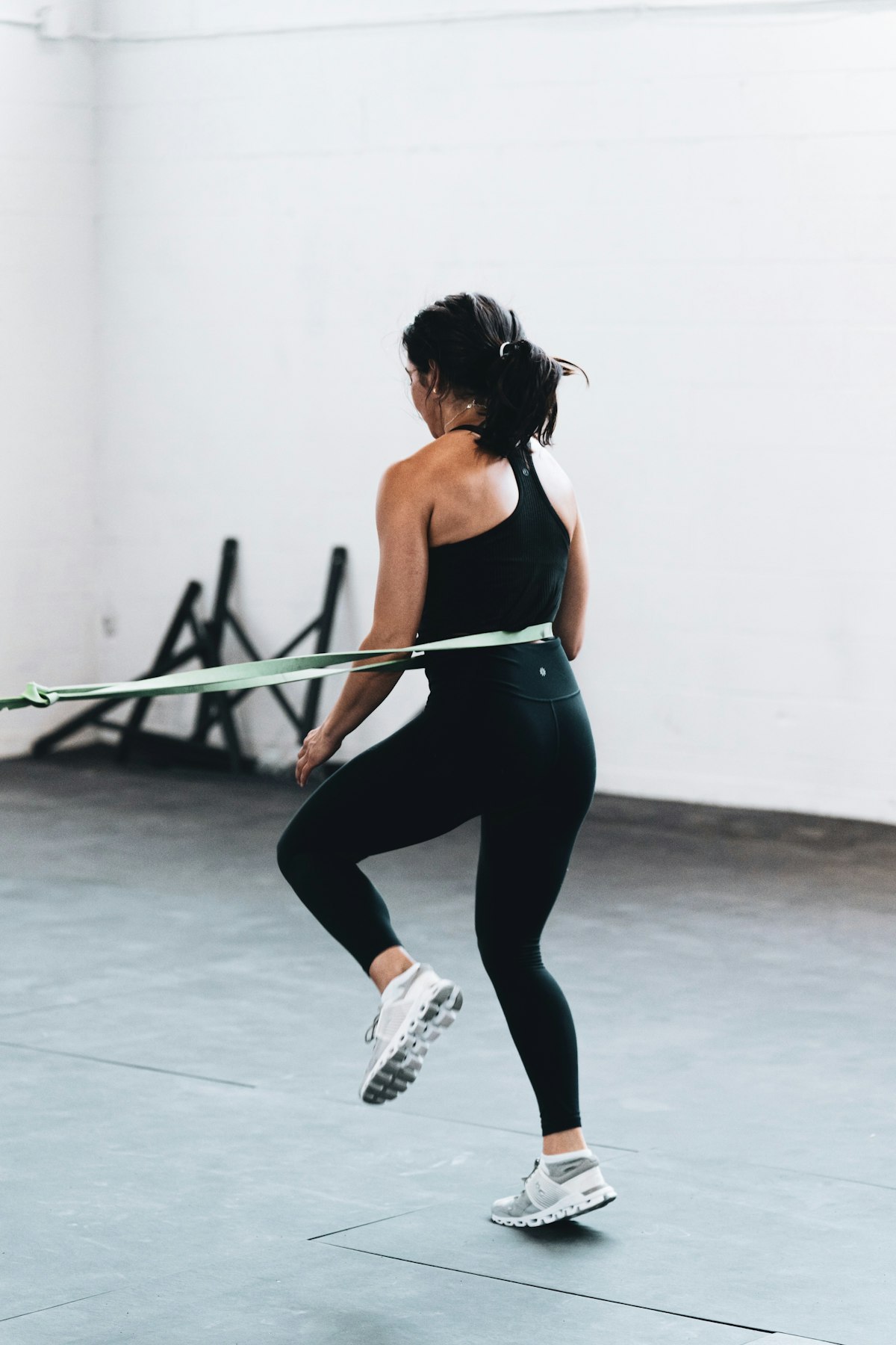 Athlete wearing fitted black leggings during resistance-band training