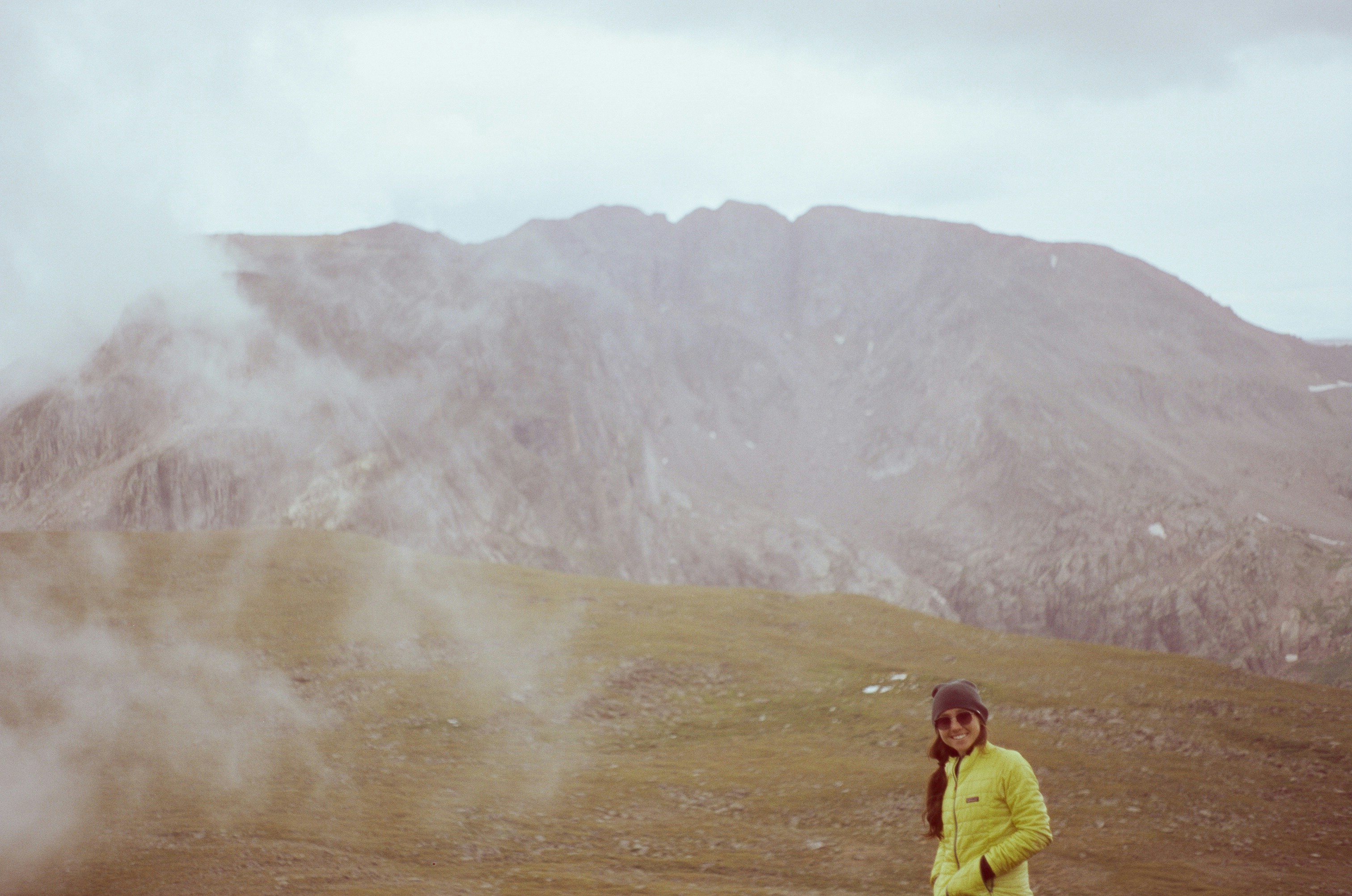 Hiker protected from the wind by a windbreaker A hiker on a windy ridge wearing a lightweight windbreaker jacket