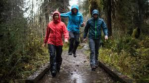 Hikers wearing colorful outdoor jackets and performance apparel on a mountain trail showcasing 2026 color trends
