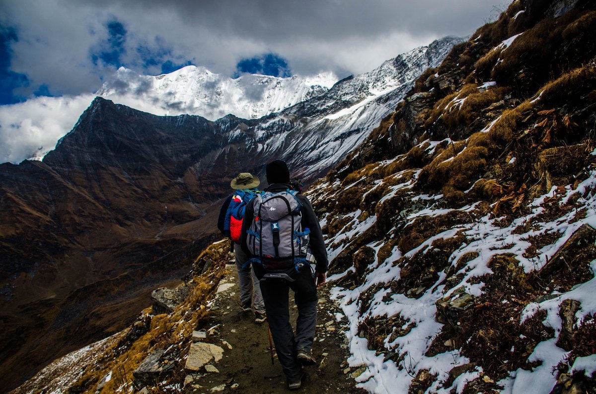 Panoramic mountain landscape with hikers in technical outdoor apparel
