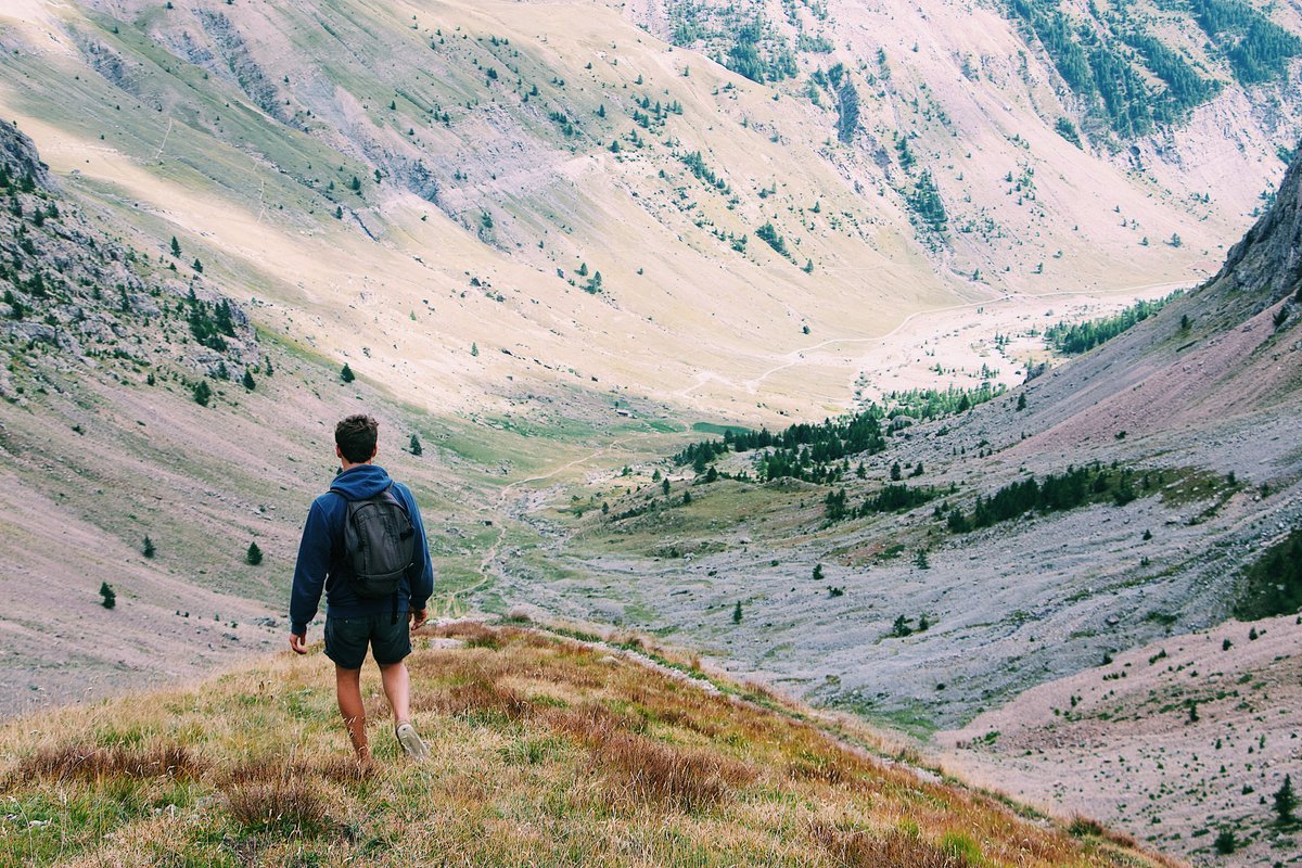 Sunset over mountain peaks with outdoor enthusiasts in premium gear