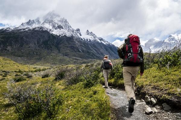 Hiker in full layering system on mountain trail