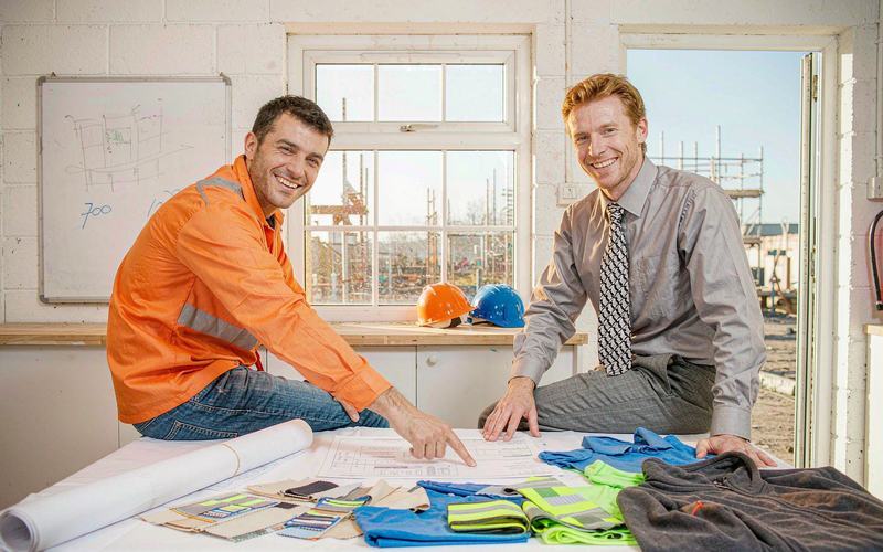 Reviewing construction workwear specification and fabric swatches before production