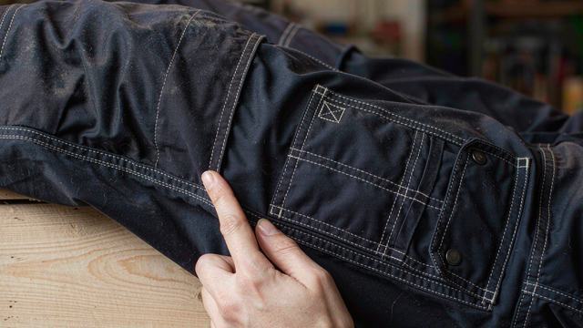 Reinforced stitching and tool system details on construction workwear