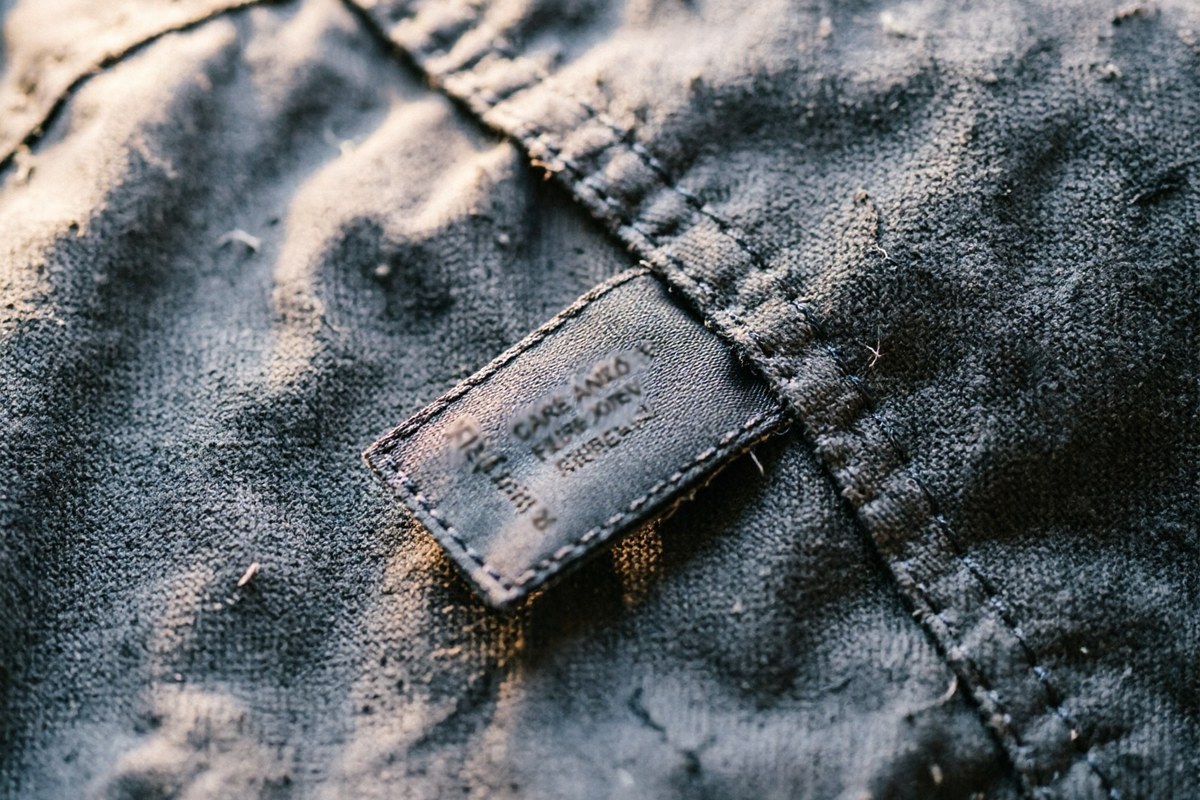 Close-up of a woven care and content label inside a recycled fabric work jacket
