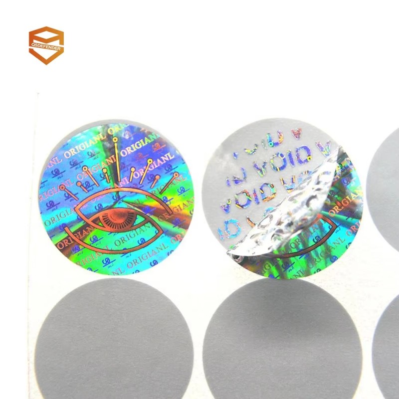 Rectangular VOID reveal-on-lift tamper-evident labels, one intact and one lifted showing the residue pattern