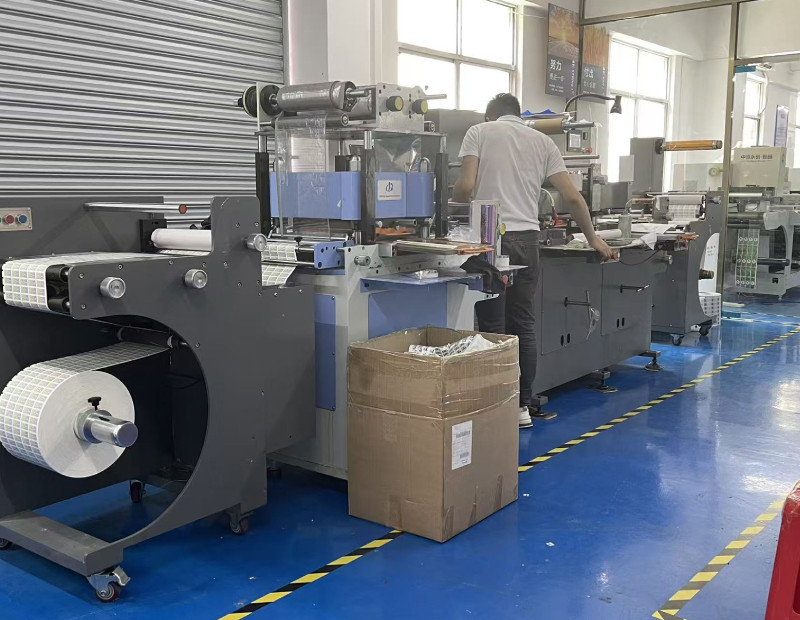 Label conversion and die-cutting line with rolls of finished labels at QS Defender's production facility
