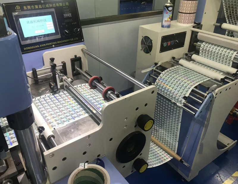 Close-up of die-cutting equipment processing sheets of printed labels