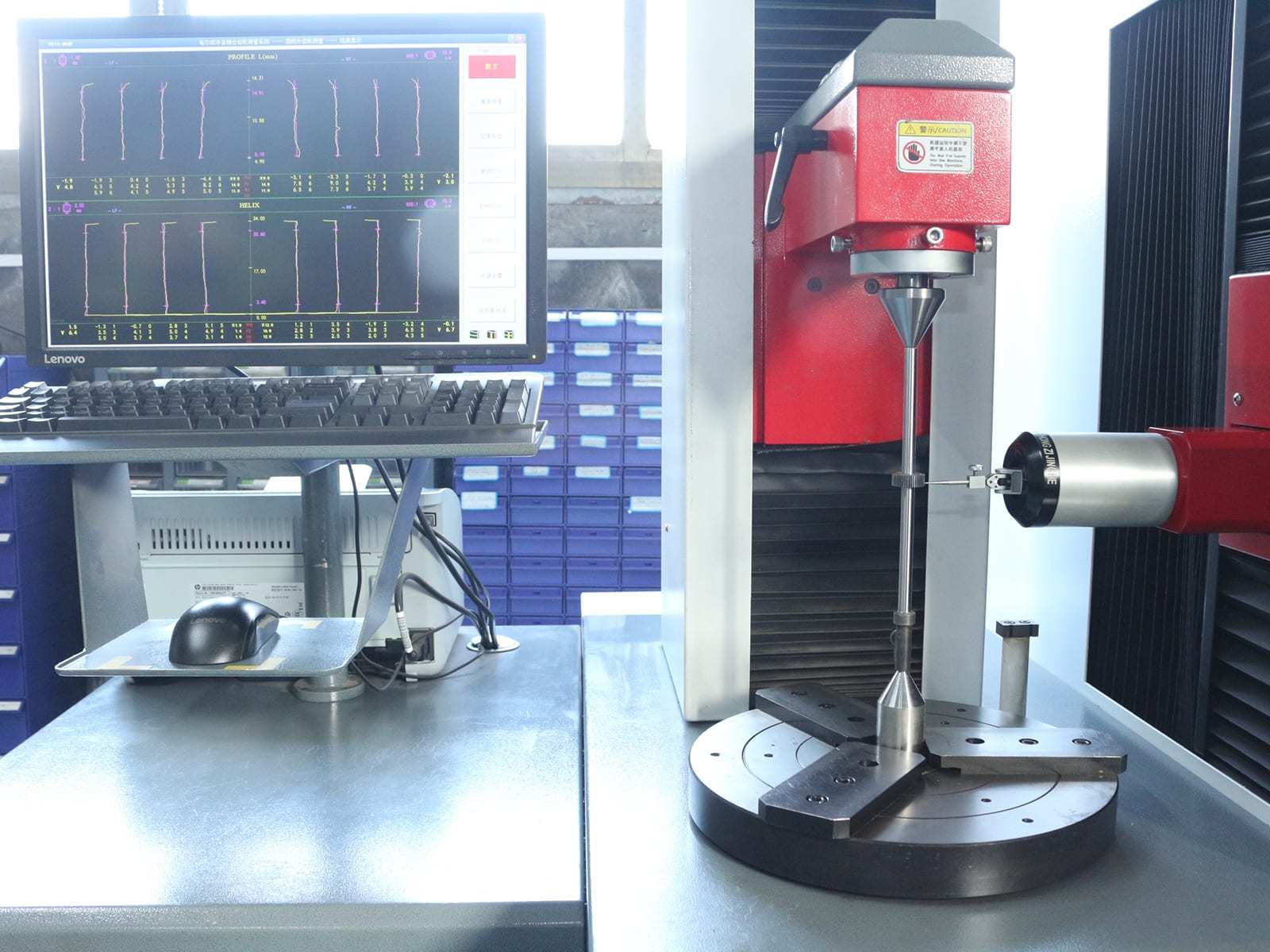 Gear profile and helix inspection displayed beside a measuring machine
