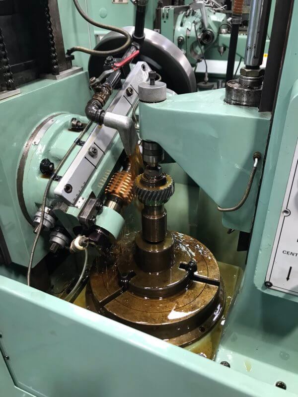 Gear hobbing machine machining a metal gear