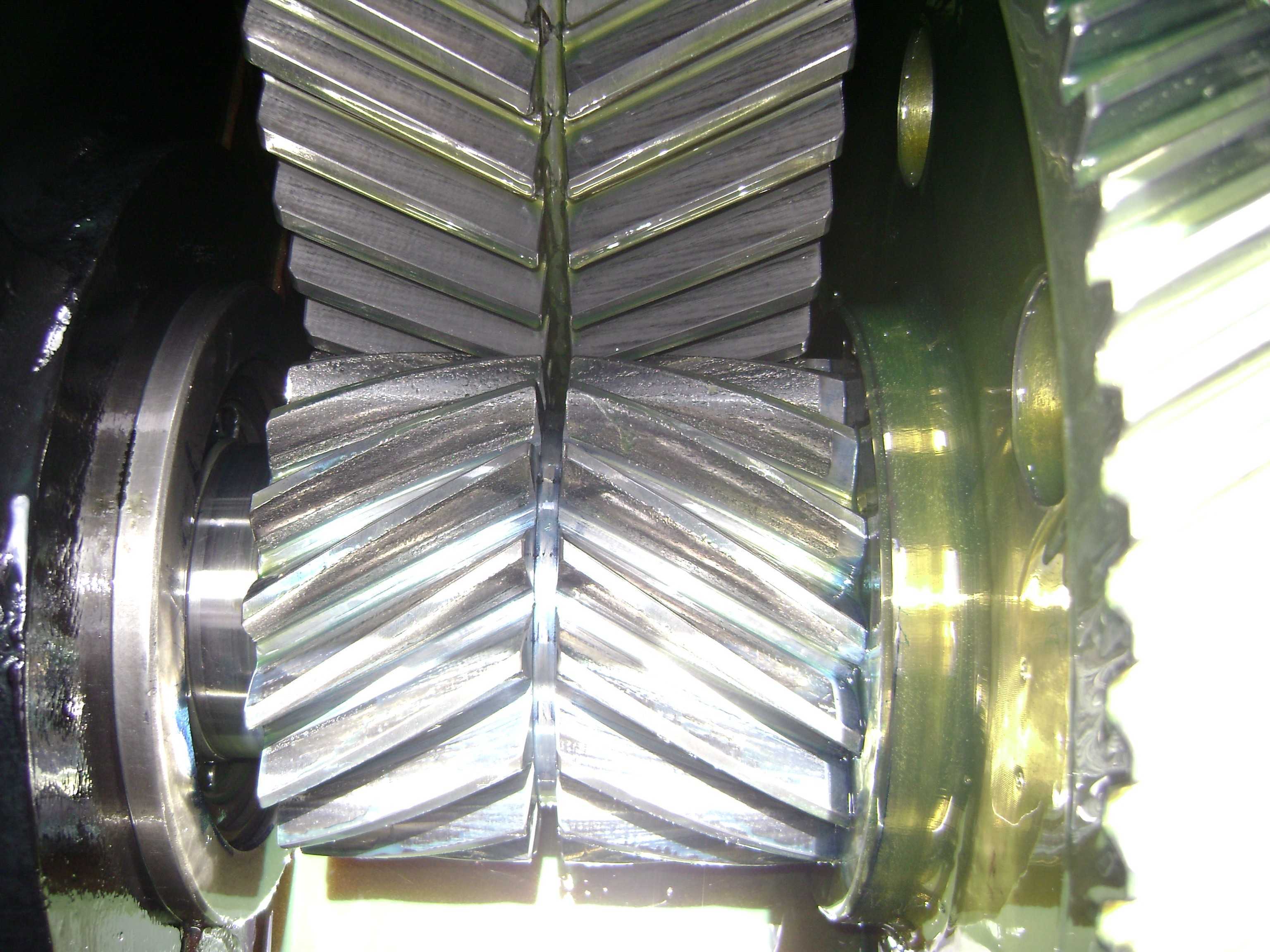 Helical gears meshing in an industrial speed reducer