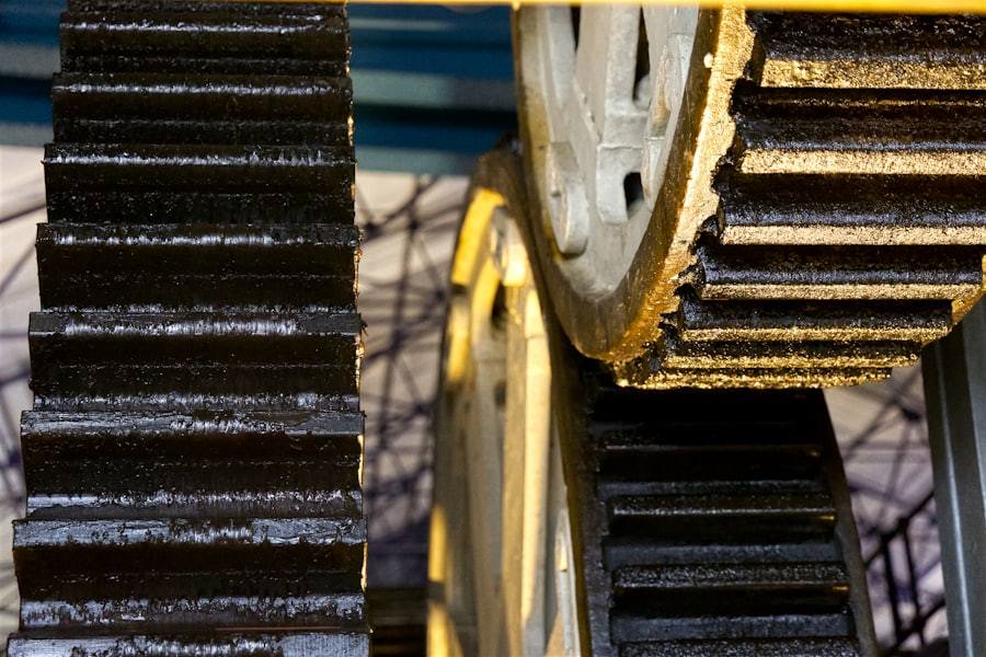 Two large meshed industrial gears in machinery.