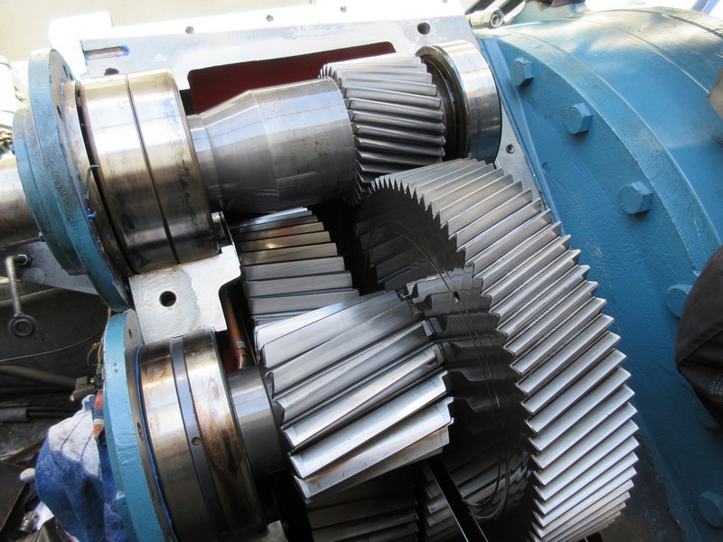 Helical gears mounted in an industrial gearbox.