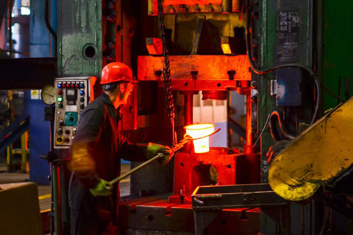 Hot metal being formed in a forging operation