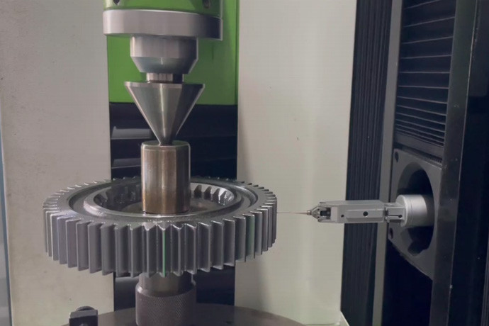 Gear mounted between centers with a measurement probe beside its teeth