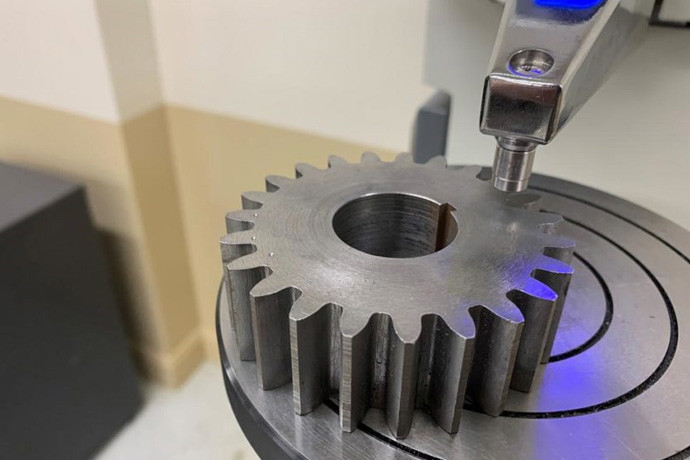 Hardness testing instrument positioned on a steel spur gear