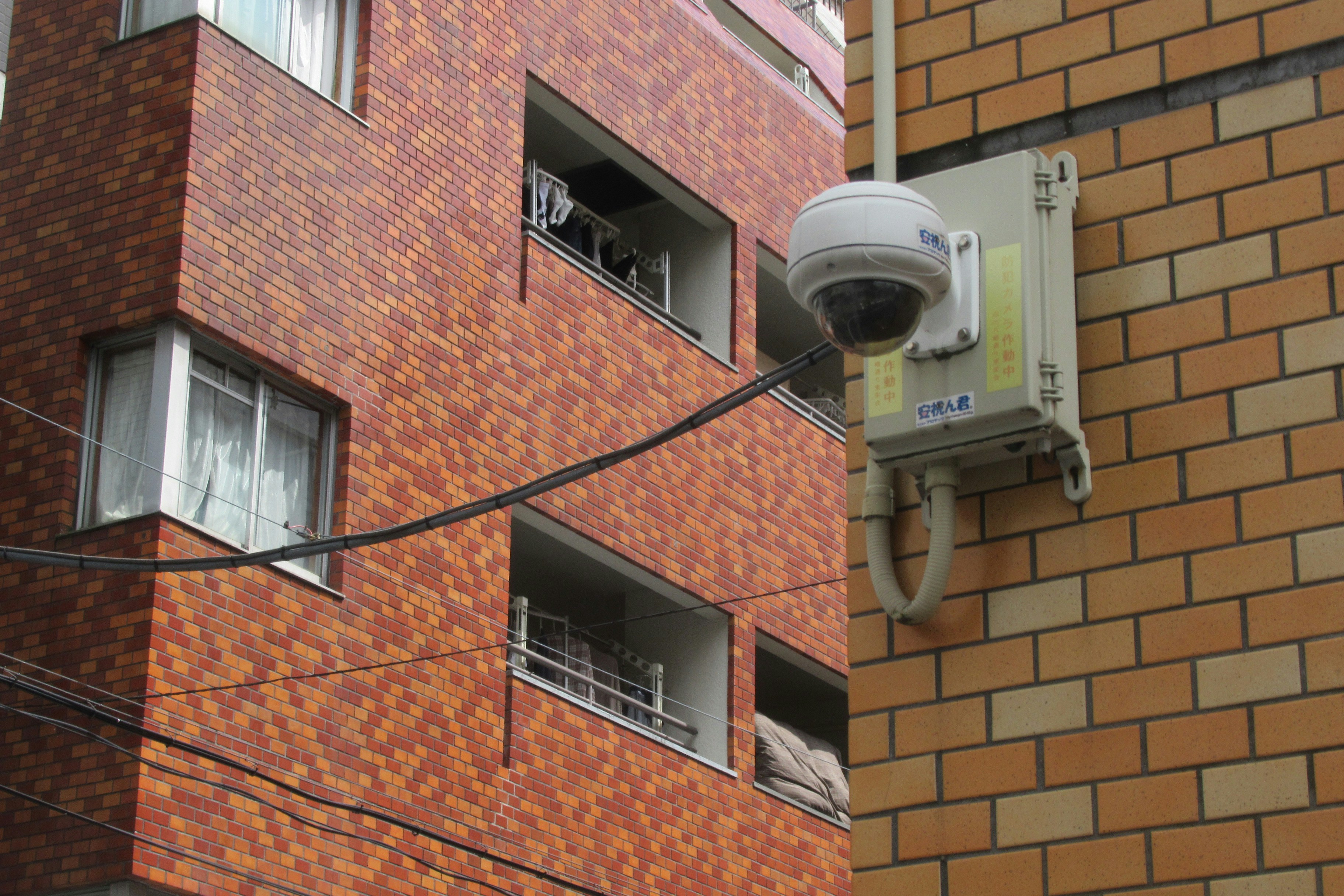 Easy DIY Installation of Wireless Security Camera A person installing a wireless security camera on an exterior wall