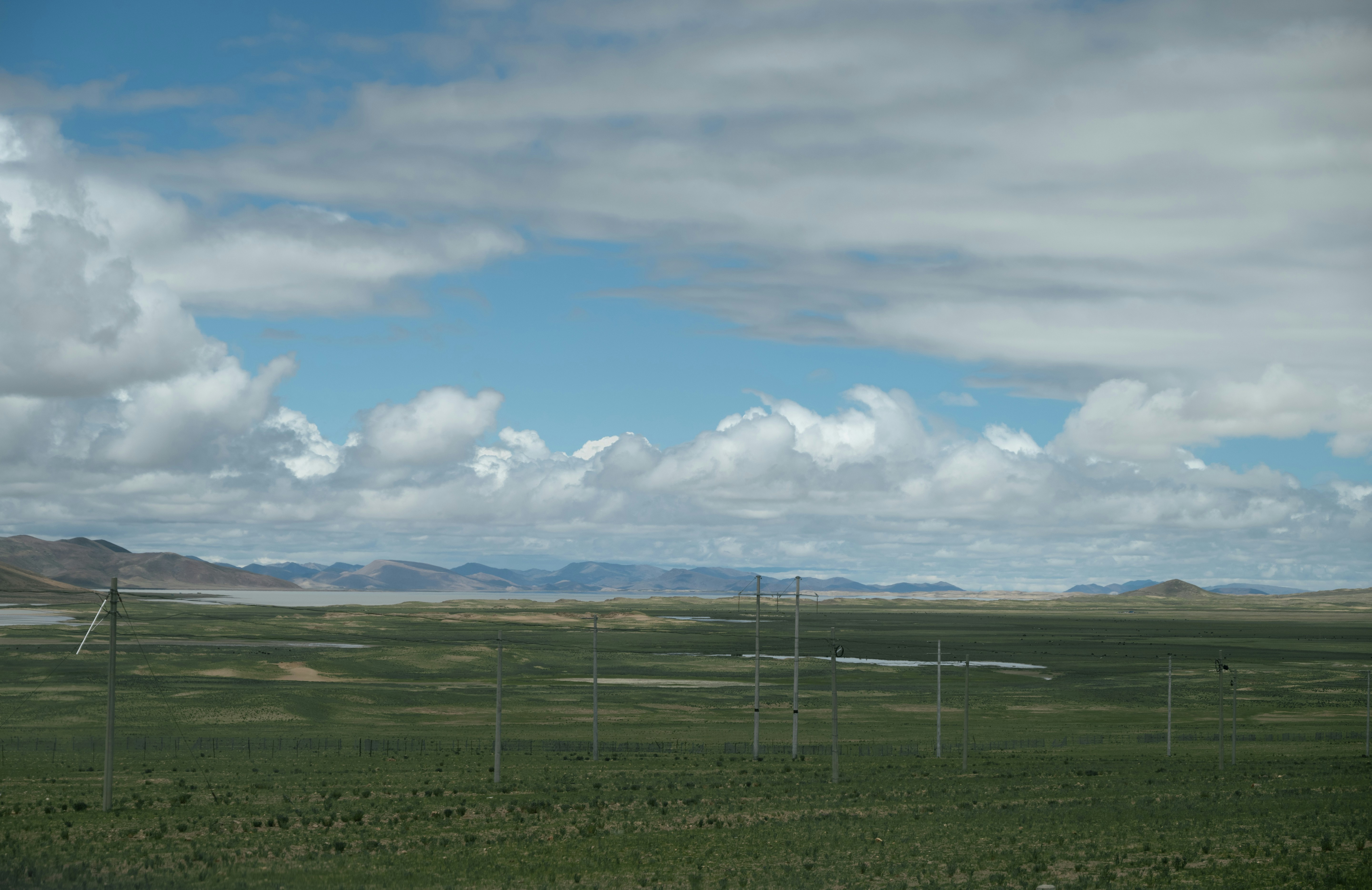 A solar-powered cellular security camera mounted on a pole in a remote field.