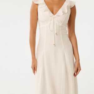 Sample Cute V-neckline With Ruffle Trim And Tie Detail Camisole  A-Line Silhouette Dress