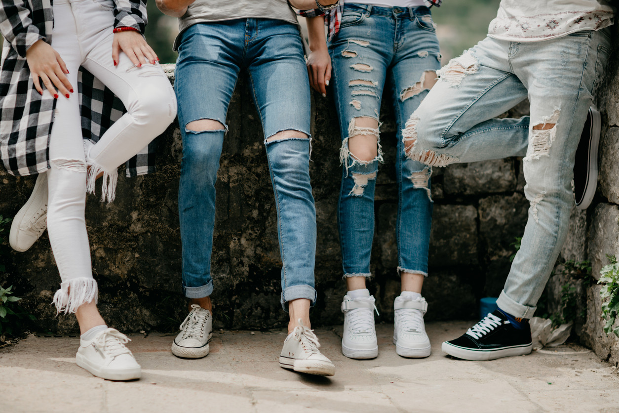 When did ripped jeans become a mainstream fashion statement, and in which decades