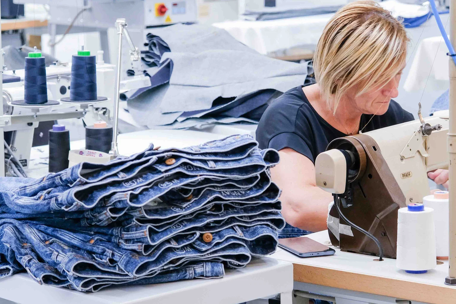 Which machinery and technology are essential for jeans manufacturing?