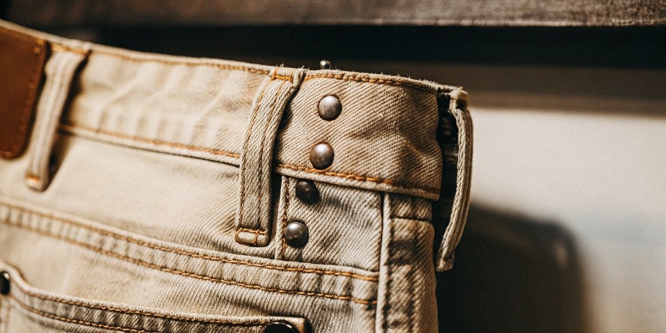 A close-up shot of the reinforced stitching and rivets on a Levi's jeans pocket.
