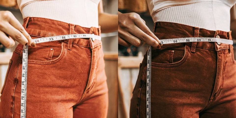 A person measuring a jean's inseam with a tape measure before and after washing, showing the length has remained the same or shrunk slightly.