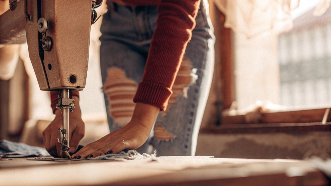Customizing destroyed jeans involves adding patches, under-fabrics, studs, embroidery, or lace for visual interest, while reinforcing weak zones with invisible stitching or fray-stopping adhesive