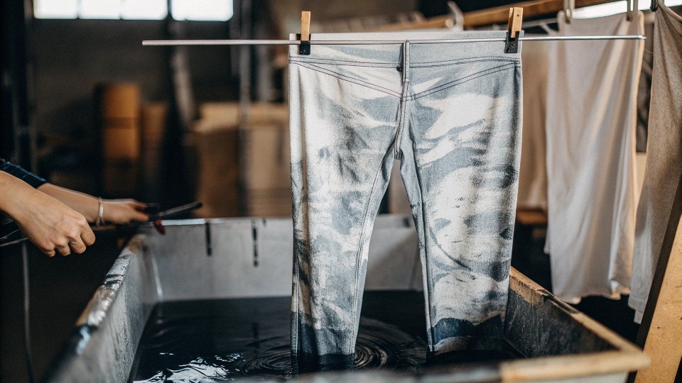 Turn patterned jeans inside out, wash on a gentle/cold cycle, and use a dye-safe detergent