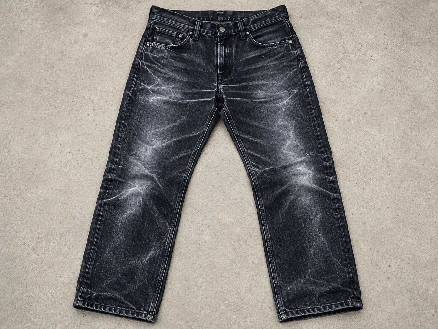 Black denim can develop white lines when friction removes surface dye, exposes lighter fibers, or damages the finish. 