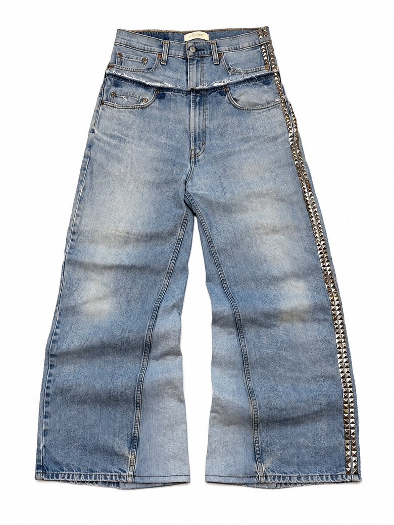 Light blue wide-leg jeans with a raw-edge double waistband and silver stud trim along one outer seam.