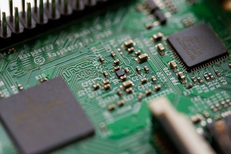 Close-up of electronic hardware and connectors on a workbench showing SMT and DIP mounting options