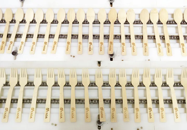 Rows of finished wooden ice cream sticks sorted by size after production