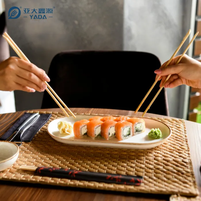 Restaurant table set with wooden chopsticks and cutlery