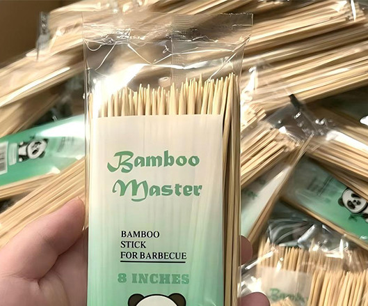 Close-up of machine-packed bamboo skewers with custom print