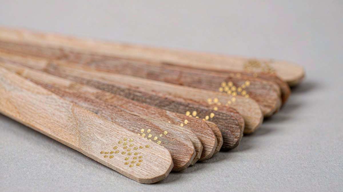 Birch wood ice cream sticks with hot-stamped gold foil branding marks