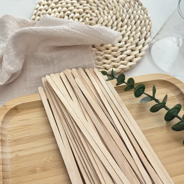 Wooden coffee stirrers laid out for cup service