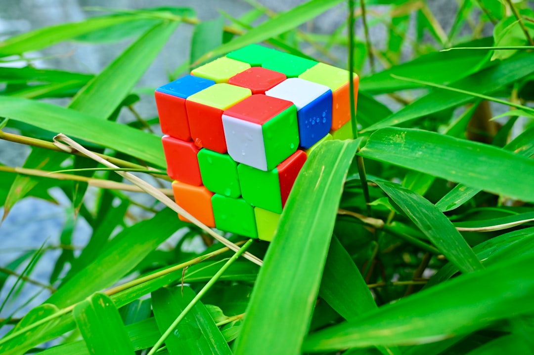 A toddler engaging with a multi-sided wooden busy cube