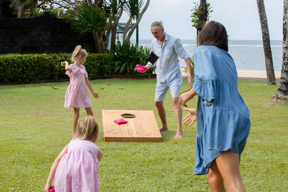 Children playing with wooden outdoor toys