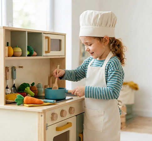 Toddler absorbed in open-ended play with wooden blocks on the floor